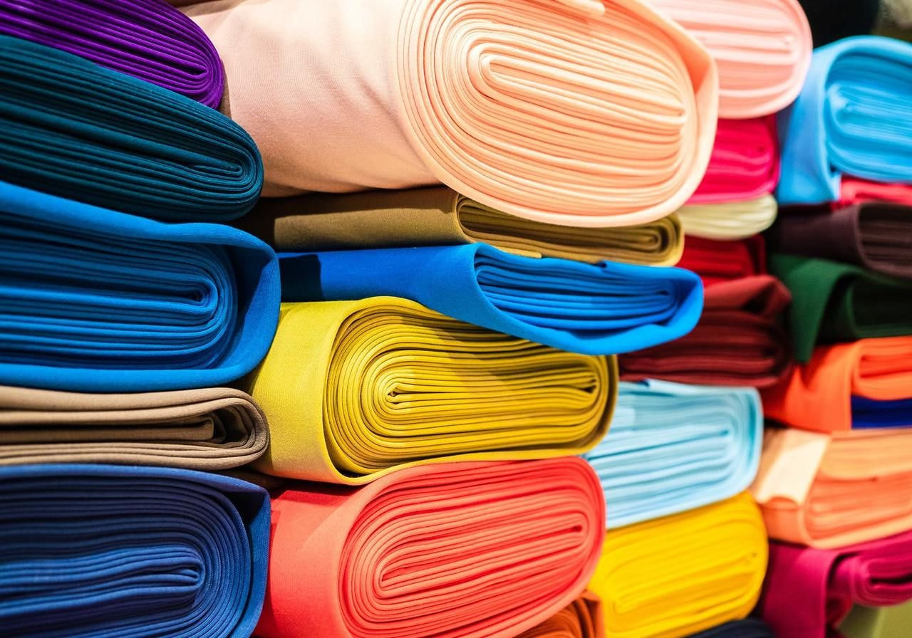 Rolls of cotton fabric in different colors.